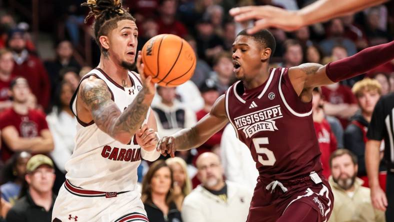 Jan 6, 2024; Columbia, South Carolina, USA; South Carolina Gamecocks guard Myles Stute (10) passes around Mississippi State Bulldogs guard Shawn Jones Jr. (5) in the first half at Colonial Life Arena. Mandatory Credit: Jeff Blake-USA TODAY Sports