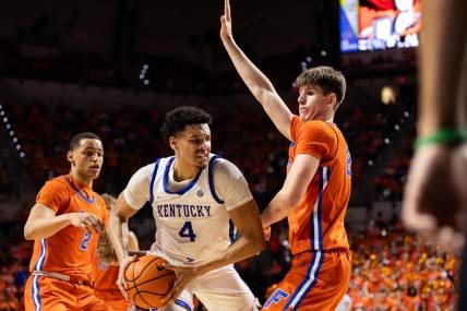 Jan 6, 2024; Gainesville, Florida, USA; Kentucky Wildcats forward Tre Mitchell (4) battles with Florida Gators forward Alex Condon (21) during the first half at Exactech Arena at the Stephen C. O'Connell Center. Mandatory Credit: Matt Pendleton-USA TODAY Sports