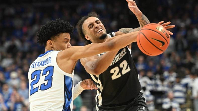 Jan 6, 2024; Omaha, Nebraska, USA; Creighton Bluejays guard Trey Alexander (23) fouls Providence Friars guard Devin Carter (22) on an attempted steal in the first half at CHI Health Center Omaha. Mandatory Credit: Steven Branscombe-USA TODAY Sports