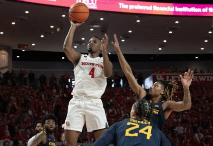 Jan 6, 2024; Houston, Texas, USA; Houston Cougars guard L.J. Cryer (4) shoots against West Virginia Mountaineers guard Noah Farrakhan (1) in the first half  at Fertitta Center. Mandatory Credit: Thomas Shea-USA TODAY Sports