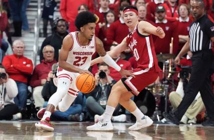 Jan 6, 2024; Madison, Wisconsin, USA; Wisconsin Badgers guard Chucky Hepburn (23) dribbles the ball against Nebraska Cornhuskers guard Keisei Tominaga (30) during the first half at the Kohl Center. Mandatory Credit: Kayla Wolf-USA TODAY Sports