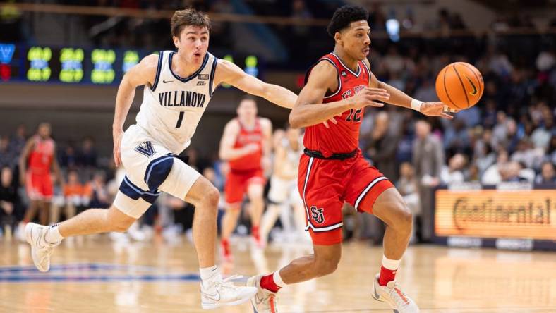 Jan 6, 2024; Villanova, Pennsylvania, USA; St. John's Red Storm guard RJ Luis Jr. (12) picks up the loose ball past Villanova Wildcats guard Brendan Hausen (1) during the second half at William B. Finneran Pavilion. Mandatory Credit: Bill Streicher-USA TODAY Sports