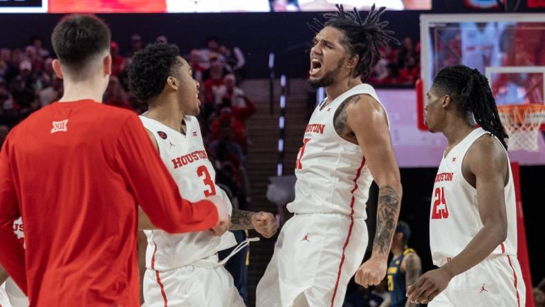 Jan 6, 2024; Houston, Texas, USA;Houston Cougars guard Emanuel Sharp (21) celebrates with guard Ramon Walker Jr. (3) against the West Virginia Mountaineers  in the first half  at Fertitta Center. Mandatory Credit: Thomas Shea-USA TODAY Sports