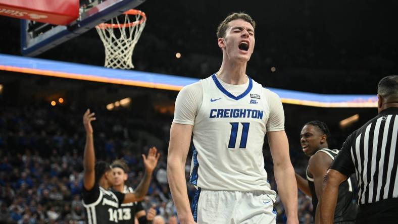 Jan 6, 2024; Omaha, Nebraska, USA; Creighton Bluejays center Ryan Kalkbrenner (11) reacts after scoring and being fouled against the Providence Friars in the second half at CHI Health Center Omaha. Mandatory Credit: Steven Branscombe-USA TODAY Sports