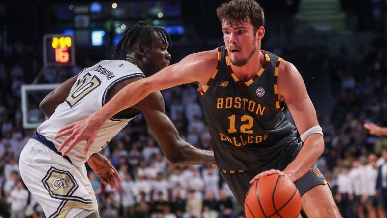 Jan 6, 2024; Atlanta, Georgia, USA; Boston College Eagles forward Quinten Post (12) drives on Georgia Tech Yellow Jackets forward Ebenezer Dowuona (10) in the first half at McCamish Pavilion. Mandatory Credit: Brett Davis-USA TODAY Sports