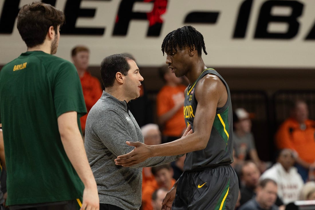 Jan 6, 2024; Stillwater, Okla, USA; Baylor Bears head coach Scott Drew talks with guard Ja'Kobe Walter (4) in the first half of an NCAA men  s basketball game against the Oklahoma State Cowboys at Gallagher-Iba arena. Mandatory Credit: Mitch Alcala-The Oklahoman