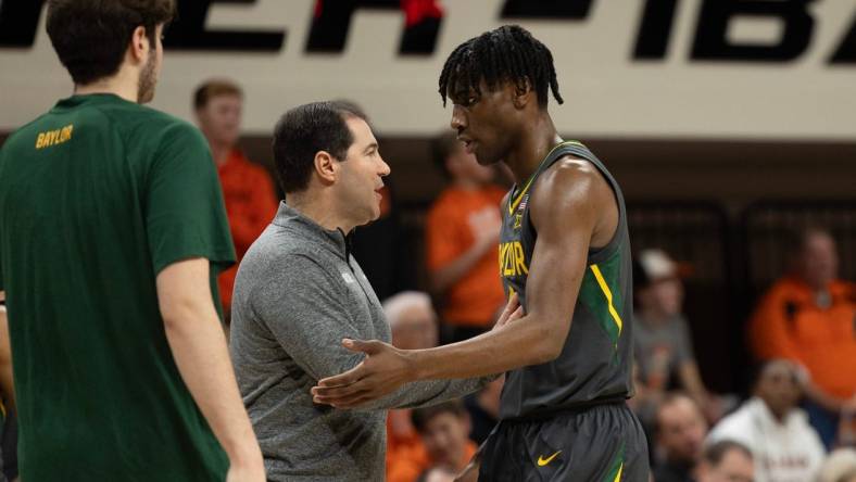 Jan 6, 2024; Stillwater, Okla, USA; Baylor Bears head coach Scott Drew talks with guard Ja'Kobe Walter (4) in the first half of an NCAA men  s basketball game against the Oklahoma State Cowboys at Gallagher-Iba arena. Mandatory Credit: Mitch Alcala-The Oklahoman