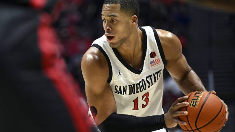 Jan 6, 2024; San Diego, California, USA; San Diego State Aztecs forward Jaedon LeDee (13) controls the ball during the first half against the UNLV Rebels at Viejas Arena. Mandatory Credit: Orlando Ramirez-USA TODAY Sports