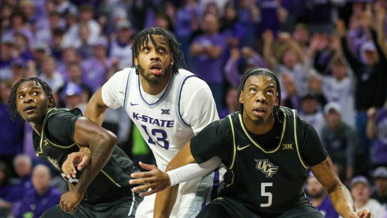 Jan 6, 2024; Manhattan, Kansas, USA; UCF Knights forwards Omar Payne (5) and Marchelus Avery (13) block out Kansas State Wildcats center Will McNair Jr. (13) for a rebound during the first half at Bramlage Coliseum. Mandatory Credit: Scott Sewell-USA TODAY Sports