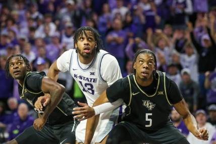 Jan 6, 2024; Manhattan, Kansas, USA; UCF Knights forwards Omar Payne (5) and Marchelus Avery (13) block out Kansas State Wildcats center Will McNair Jr. (13) for a rebound during the first half at Bramlage Coliseum. Mandatory Credit: Scott Sewell-USA TODAY Sports