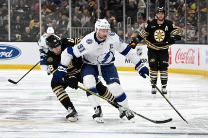 Jan 6, 2024; Boston, Massachusetts, USA; Tampa Bay Lightning center Steven Stamkos (91) controls the puck against Boston Bruins center Pavel Zacha (18) during the second period at the TD Garden. Mandatory Credit: Brian Fluharty-USA TODAY Sports