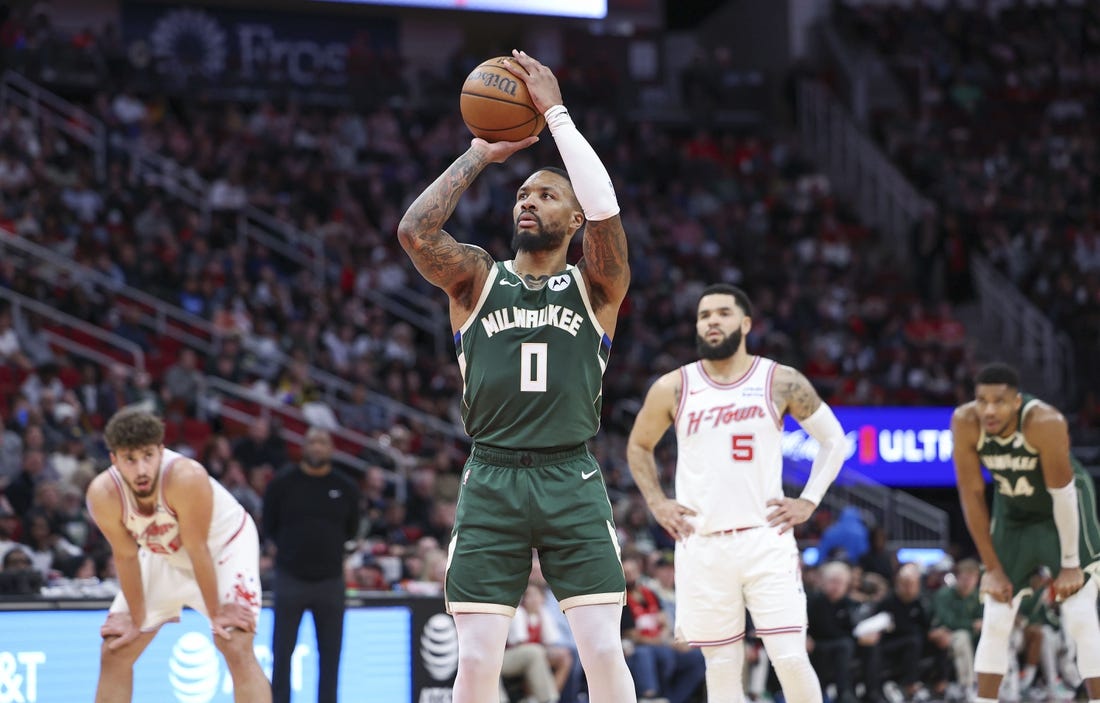 Jan 6, 2024; Houston, Texas, USA; Milwaukee Bucks guard Damian Lillard (0) attempts a free throw during the second quarter against the Houston Rockets at Toyota Center. Mandatory Credit: Troy Taormina-USA TODAY Sports