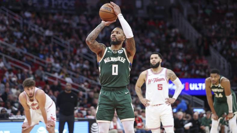 Jan 6, 2024; Houston, Texas, USA; Milwaukee Bucks guard Damian Lillard (0) attempts a free throw during the second quarter against the Houston Rockets at Toyota Center. Mandatory Credit: Troy Taormina-USA TODAY Sports