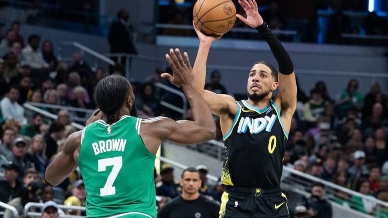 Jan 6, 2024; Indianapolis, Indiana, USA; Indiana Pacers guard Tyrese Haliburton (0) shoots the ball against Boston Celtics guard Jaylen Brown (7) in the second half at Gainbridge Fieldhouse. Mandatory Credit: Trevor Ruszkowski-USA TODAY Sports