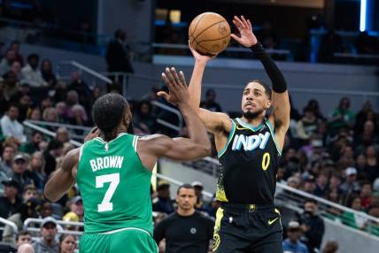 Jan 6, 2024; Indianapolis, Indiana, USA; Indiana Pacers guard Tyrese Haliburton (0) shoots the ball against Boston Celtics guard Jaylen Brown (7) in the second half at Gainbridge Fieldhouse. Mandatory Credit: Trevor Ruszkowski-USA TODAY Sports