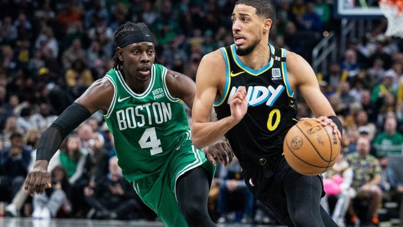 Jan 6, 2024; Indianapolis, Indiana, USA; Indiana Pacers guard Tyrese Haliburton (0) dribbles the ball against Boston Celtics guard Jrue Holiday (4) in the second half at Gainbridge Fieldhouse. Mandatory Credit: Trevor Ruszkowski-USA TODAY Sports