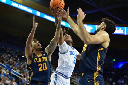 Jan 6, 2024; Los Angeles, California, USA; UCLA Bruins guard Brandon Williams (5) plays for the rebound against California Golden Bears guard Jaylon Tyson (20) and forward Fardaws Aimaq (00) during the first half at Pauley Pavilion. Mandatory Credit: Gary A. Vasquez-USA TODAY Sports