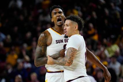Jan. 6, 2024; Phoenix, Ariz; USA; ASU guard Jose Perez (12) holds back center Shawn Phillips Jr. (9) from arguing with an official during a game against Colorado at Desert Financial Arena.