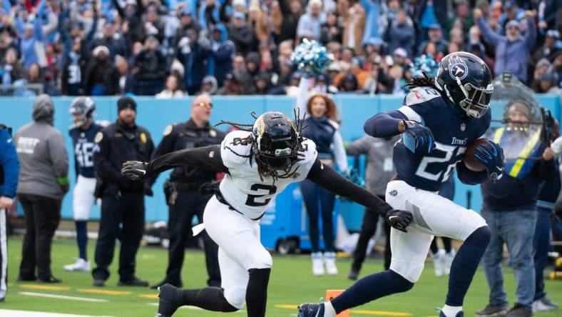 Tennessee Titans running back Derrick Henry (22) runs past Jacksonville Jaguars safety Rayshawn Jenkins (2) for a touchdown in the second quarter of their game at Nissan Stadium in Nashville, Tenn., Sunday, Jan. 7, 2024.