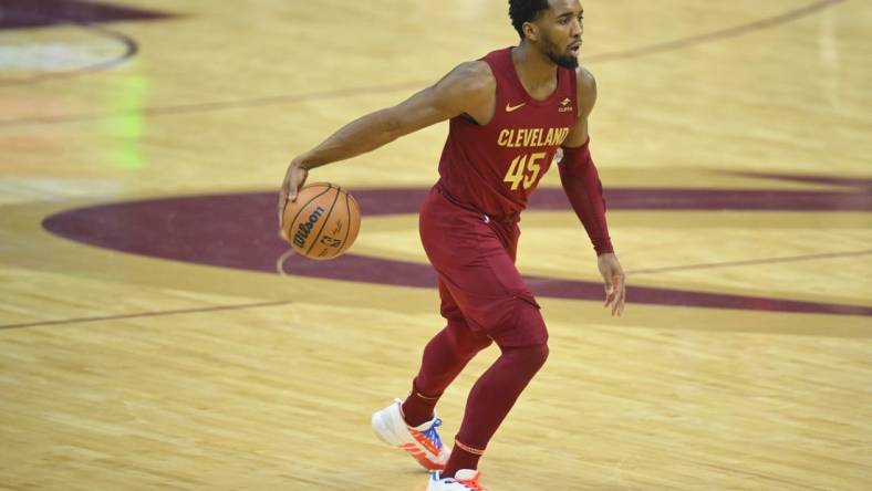 Jan 7, 2024; Cleveland, Ohio, USA; Cleveland Cavaliers guard Donovan Mitchell (45) dribbles the ball in the first quarter against the San Antonio Spurs at Rocket Mortgage FieldHouse. Mandatory Credit: David Richard-USA TODAY Sports