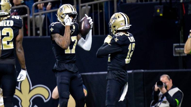 Jan 7, 2024; New Orleans, Louisiana, USA;  New Orleans Saints wide receiver A.T. Perry (17) celebrates a touchdown with wide receiver Chris Olave (12) against the Atlanta Falcons during the first half at Caesars Superdome. Mandatory Credit: Stephen Lew-USA TODAY Sports