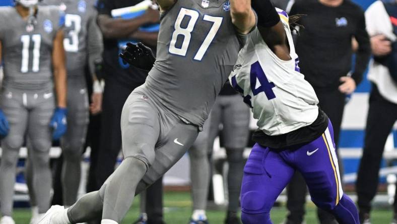 Jan 7, 2024; Detroit, Michigan, USA; Detroit Lions tight end Sam LaPorta (87) catches a pass in front of Minnesota Vikings safety Josh Metellus (44) in the second quarter at Ford Field. Mandatory Credit: Lon Horwedel-USA TODAY Sports