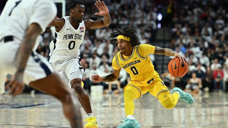 Jan 7, 2024; Philadelphia, Pennsylvania, USA; Michigan Wolverines guard Dug McDaniel (0) drives against Penn State Nittany Lions guard Kanye Clary (0) in the second half at The Palestra. Mandatory Credit: Kyle Ross-USA TODAY Sports