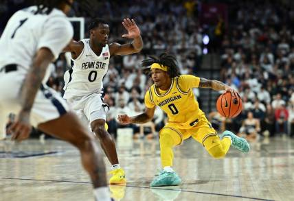 Jan 7, 2024; Philadelphia, Pennsylvania, USA; Michigan Wolverines guard Dug McDaniel (0) drives against Penn State Nittany Lions guard Kanye Clary (0) in the second half at The Palestra. Mandatory Credit: Kyle Ross-USA TODAY Sports