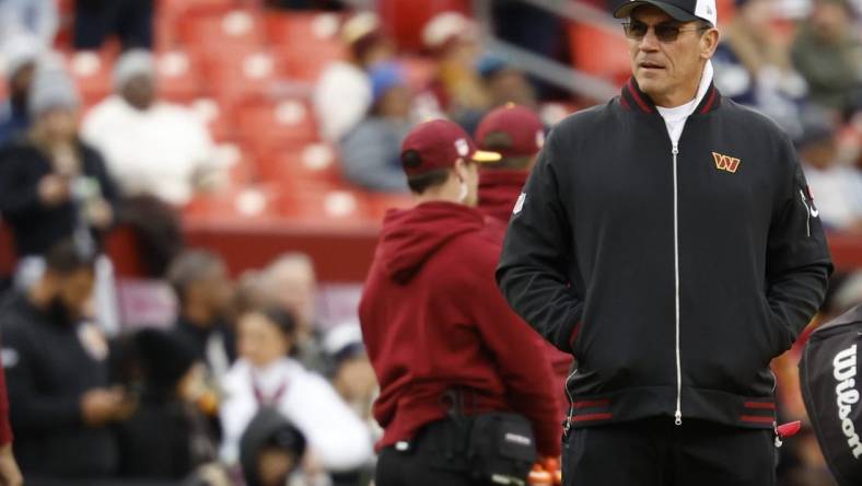 Jan 7, 2024; Landover, Maryland, USA; Washington Commanders head coach Ron Rivera stands on the field during warmups prior to the game against the Dallas Cowboys at FedExField. Mandatory Credit: Geoff Burke-USA TODAY Sports