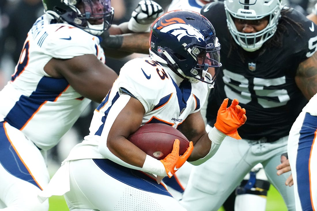 Jan 7, 2024; Paradise, Nevada, USA; Denver Broncos running back Javonte Williams (33) carries against the Las Vegas Raiders during the first quarter at Allegiant Stadium. Mandatory Credit: Stephen R. Sylvanie-USA TODAY Sports