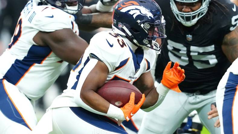 Jan 7, 2024; Paradise, Nevada, USA; Denver Broncos running back Javonte Williams (33) carries against the Las Vegas Raiders during the first quarter at Allegiant Stadium. Mandatory Credit: Stephen R. Sylvanie-USA TODAY Sports