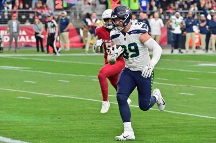 Jan 7, 2024; Glendale, Arizona, USA; Seattle Seahawks tight end Will Dissly (89) scores a touchdown in the first half against the Arizona Cardinals at State Farm Stadium. Mandatory Credit: Matt Kartozian-USA TODAY Sports