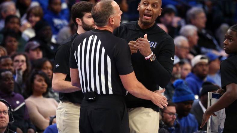 Jan 7, 2024; Memphis, Tennessee, USA; Memphis Tigers head coach  Penny Hardaway (right) is held back by an official during the first half against the Southern Methodist Mustangs at FedExForum. Mandatory Credit: Petre Thomas-USA TODAY Sports