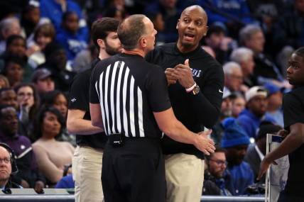 Jan 7, 2024; Memphis, Tennessee, USA; Memphis Tigers head coach  Penny Hardaway (right) is held back by an official during the first half against the Southern Methodist Mustangs at FedExForum. Mandatory Credit: Petre Thomas-USA TODAY Sports