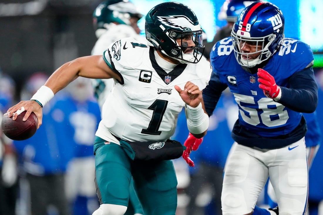 New York Giants linebacker Bobby Okereke (58) goes after Philadelphia Eagles quarterback Jalen Hurts (1) just before sacking him in the second quarter, Sunday, January 7, 2024.