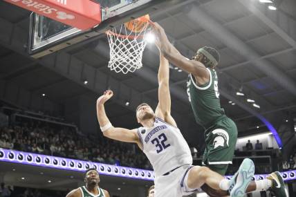 Jan 7, 2024; Evanston, Illinois, USA; Michigan State Spartans forward Coen Carr (55) goes up for a dunk on Northwestern Wildcats forward Blake Preston (32) during the first half at Welsh-Ryan Arena. Mandatory Credit: David Banks-USA TODAY Sports