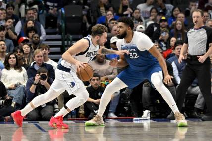 Jan 7, 2024; Dallas, Texas, USA; Dallas Mavericks guard Luka Doncic (77) drives to the basket past Minnesota Timberwolves center Karl-Anthony Towns (32) during the second quarter at the American Airlines Center. Mandatory Credit: Jerome Miron-USA TODAY Sports