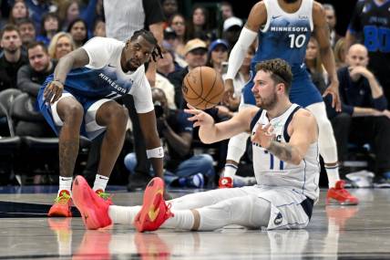 Jan 7, 2024; Dallas, Texas, USA; Dallas Mavericks guard Luka Doncic (77) passes the ball in front of Minnesota Timberwolves center Naz Reid (11) during the second quarter at the American Airlines Center. Mandatory Credit: Jerome Miron-USA TODAY Sports