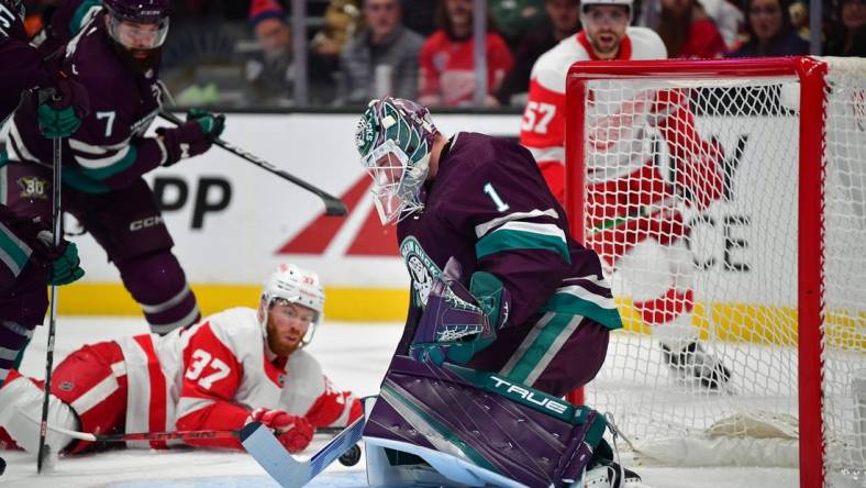 Jan 7, 2024; Anaheim, California, USA; Anaheim Ducks goaltender Lukas Dostal (1) blocks a shot against the Detroit Red Wings during the first period at Honda Center. Mandatory Credit: Gary A. Vasquez-USA TODAY Sports