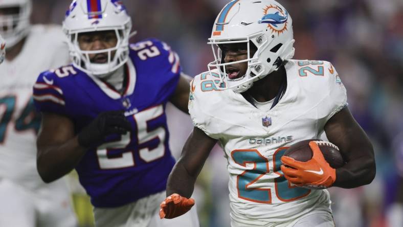 Jan 7, 2024; Miami Gardens, Florida, USA; Miami Dolphins running back De'Von Achane (28) runs with the football against the Buffalo Bills during the first quarter at Hard Rock Stadium. Mandatory Credit: Sam Navarro-USA TODAY Sports