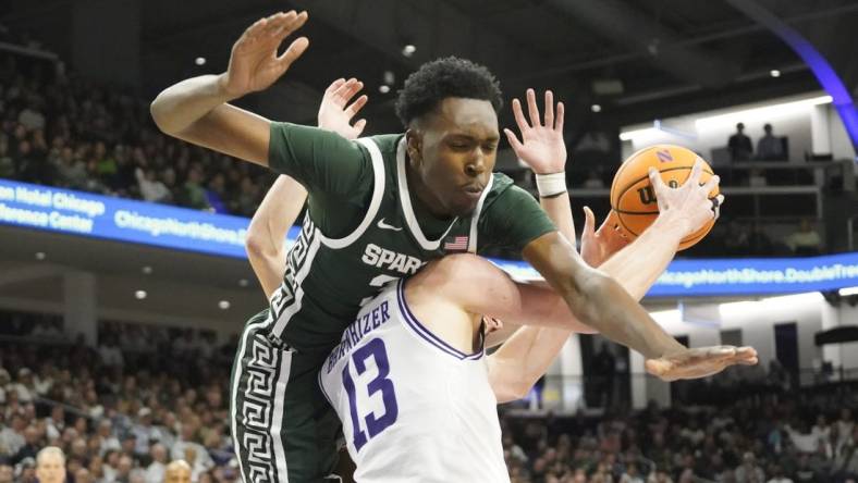 Jan 7, 2024; Evanston, Illinois, USA; Michigan State Spartans forward Xavier Booker (34) defends Northwestern Wildcats guard Brooks Barnhizer (13) during the second half at Welsh-Ryan Arena. Mandatory Credit: David Banks-USA TODAY Sports