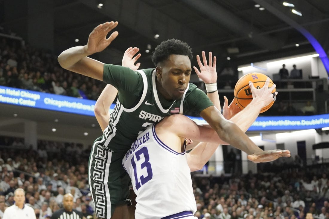 Jan 7, 2024; Evanston, Illinois, USA; Michigan State Spartans forward Xavier Booker (34) defends Northwestern Wildcats guard Brooks Barnhizer (13) during the second half at Welsh-Ryan Arena. Mandatory Credit: David Banks-USA TODAY Sports