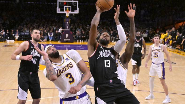 Jan 7, 2024; Los Angeles, California, USA;  Los Angeles Clippers forward Paul George (13) shoots over Los Angeles Lakers forward Anthony Davis (3) in the second half at Crypto.com Arena. Mandatory Credit: Jayne Kamin-Oncea-USA TODAY Sports