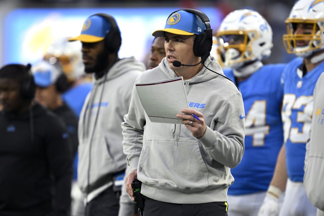 Jan 7, 2024; Inglewood, California, USA; Los Angeles Chargers offensive coordinator Kellen Moore looks on during the second half against the Kansas City Chiefs at SoFi Stadium. Mandatory Credit: Orlando Ramirez-USA TODAY Sports