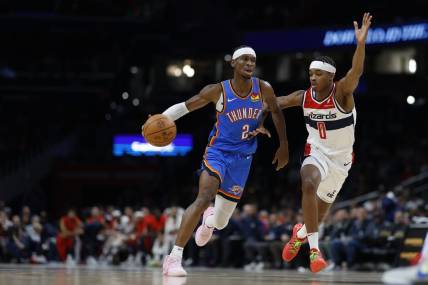 Jan 8, 2024; Washington, District of Columbia, USA; Oklahoma City Thunder guard Shai Gilgeous-Alexander (2) drives to the basket as Washington Wizards guard Bilal Coulibaly (0) defends in the second quarter at Capital One Arena. Mandatory Credit: Geoff Burke-USA TODAY Sports
