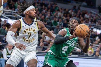 Jan 8, 2024; Indianapolis, Indiana, USA; Boston Celtics guard Jrue Holiday (4) shoots the ball while Indiana Pacers guard Buddy Hield (7) defends in the first half at Gainbridge Fieldhouse. Mandatory Credit: Trevor Ruszkowski-USA TODAY Sports