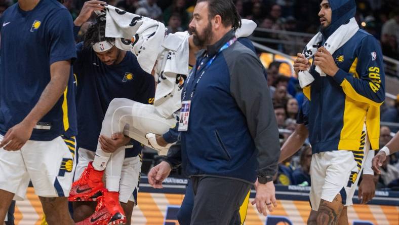 Jan 8, 2024; Indianapolis, Indiana, USA; Indiana Pacers guard Tyrese Haliburton (0) is carried off the court with apparent leg injury in the first half at Gainbridge Fieldhouse. Mandatory Credit: Trevor Ruszkowski-USA TODAY Sports