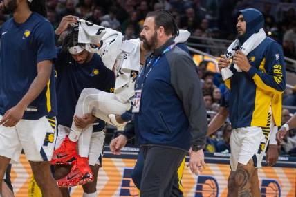 Jan 8, 2024; Indianapolis, Indiana, USA; Indiana Pacers guard Tyrese Haliburton (0) is carried off the court with apparent leg injury in the first half at Gainbridge Fieldhouse. Mandatory Credit: Trevor Ruszkowski-USA TODAY Sports