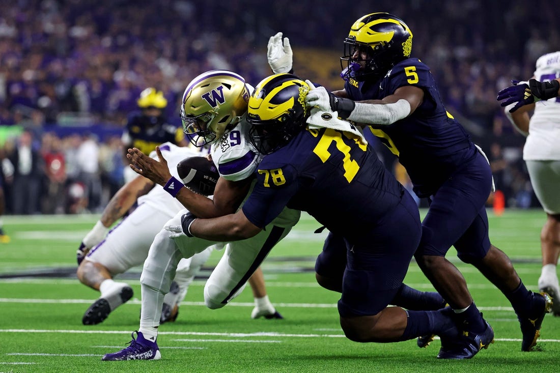 Jan 8, 2024; Houston, TX, USA; Michigan Wolverines defensive lineman Kenneth Grant (78) sakes Washington Huskies quarterback Michael Penix Jr. (9) during the second quarter in the 2024 College Football Playoff national championship game at NRG Stadium. Mandatory Credit: Troy Taormina-USA TODAY Sports