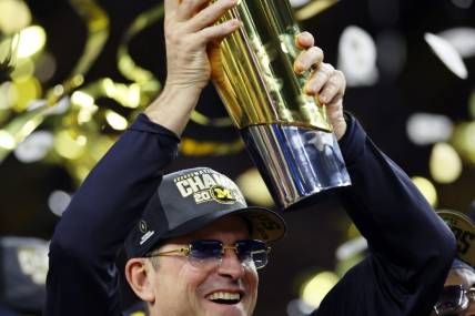 Jan 8, 2024; Houston, TX, USA; Michigan Wolverines head coach Jim Harbaugh holds the National Championship Trophy as he celebrates after winning 2024 College Football Playoff national championship game against the Washington Huskies at NRG Stadium. Mandatory Credit: Thomas Shea-USA TODAY Sports